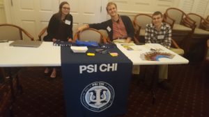 Psi Chi executive board members welcome students to the Graduate School Expo.